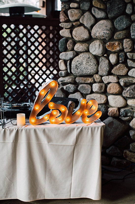 Illuminated Love sign on table at wedding reception