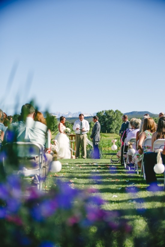 Outdoor wedding ceremony with mountains in background