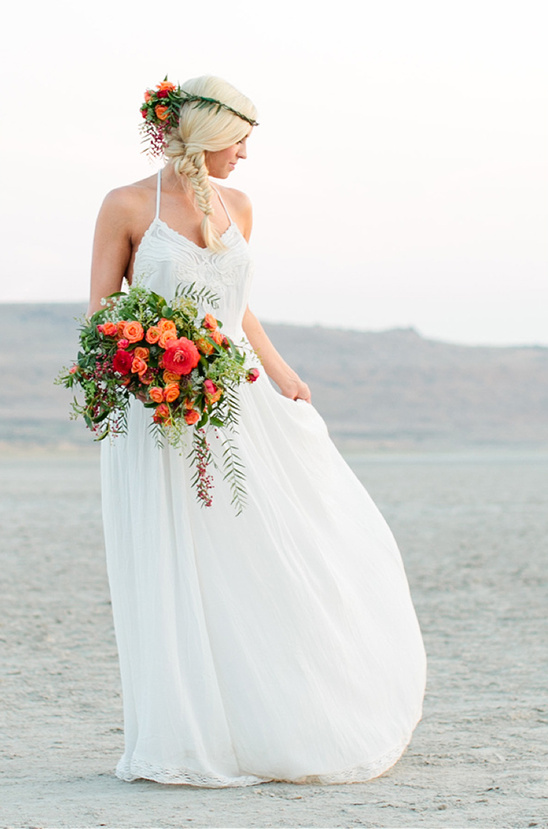 Bride in white dress with bright bouquet flower crown