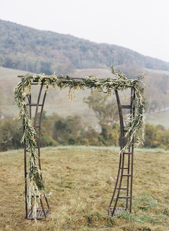 greenery decorated wedding arch