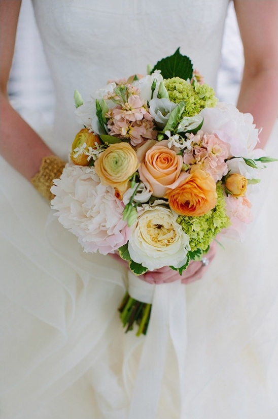 Bride holding a beautiful peach and white rose bouquet