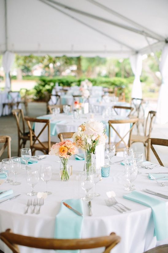 Wedding reception table with flowers and blue accents