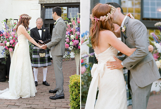 Bride and groom share a kiss during a romantic outdoor wedding ceremony