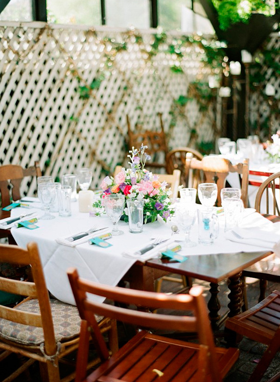 Elegant outdoor dining table decorated with flowers and place settings