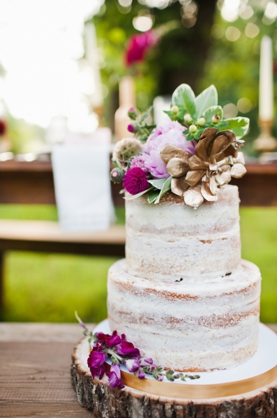 purple and gold floral topped naked cake