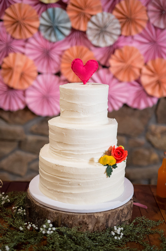 wedding cake with paper fan backdrop