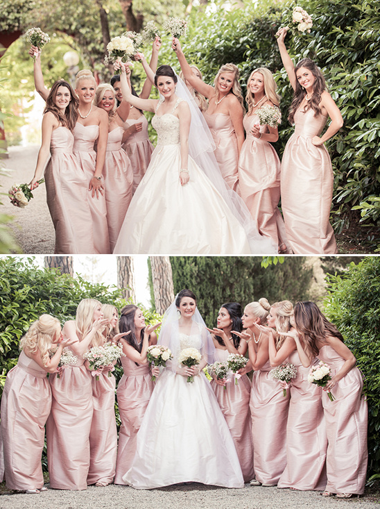 Bride and bridesmaids in pink dresses celebrate wedding