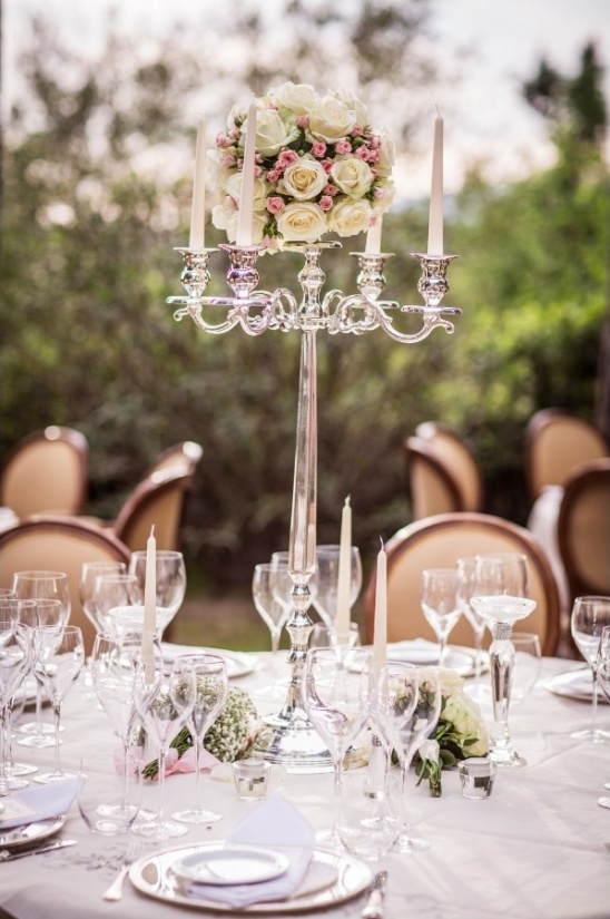 Elegant wedding table with rose centerpiece and candelabra
