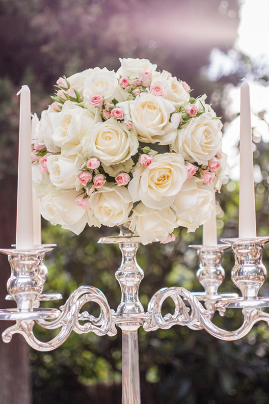 Elegant centerpiece with white roses and silver candelabra