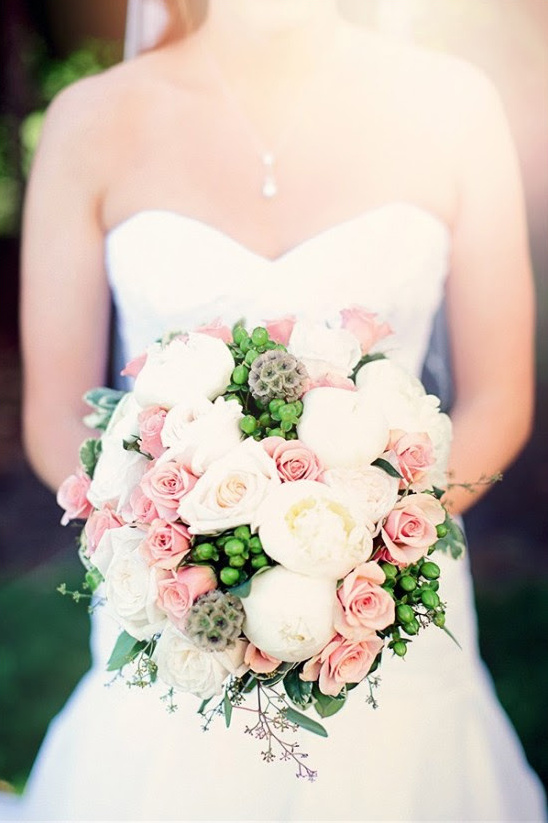 Elegant bride holds pink and white wedding bouquet