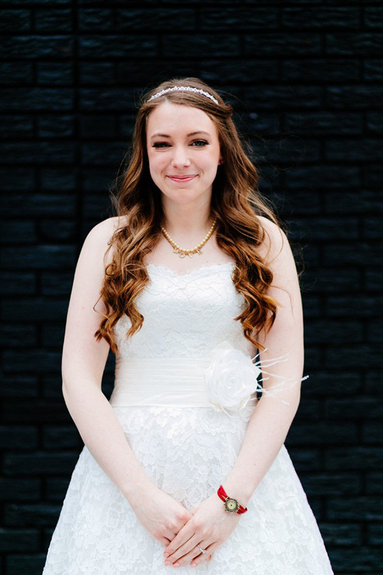 Beautiful bride in white wedding dress smiles for camera