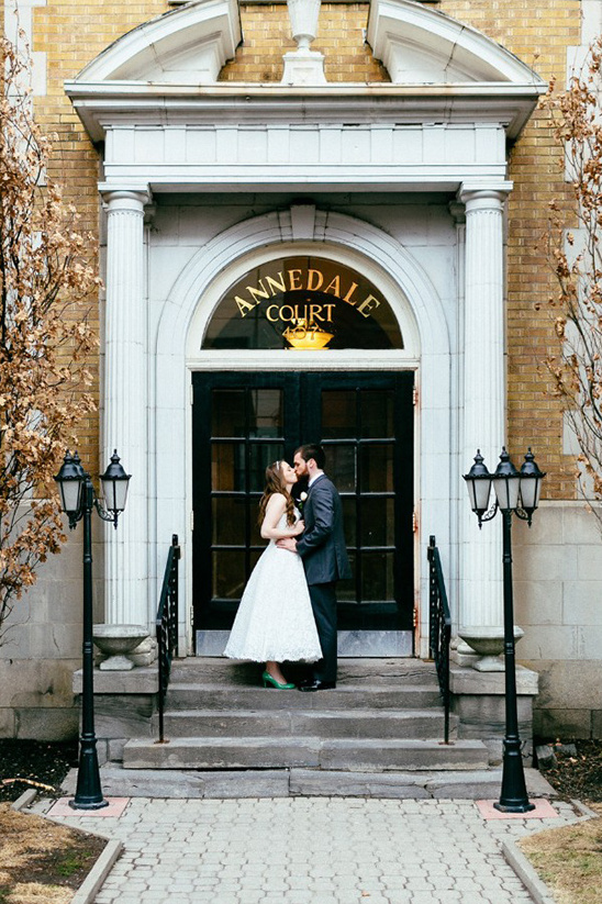Bride and groom sharing a kiss on the steps of Annedale Court