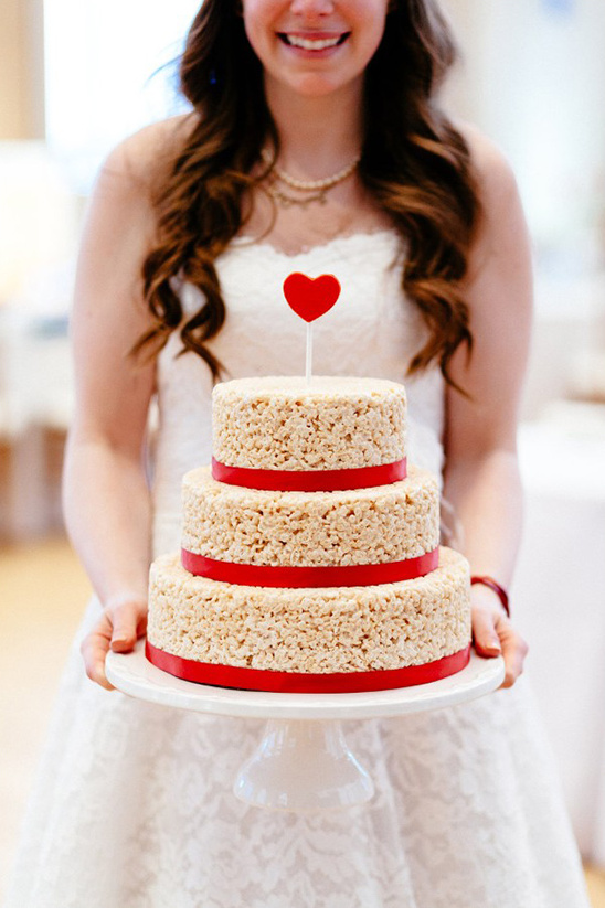 Bride holding a Rice Krispie treat wedding cake with a red heart