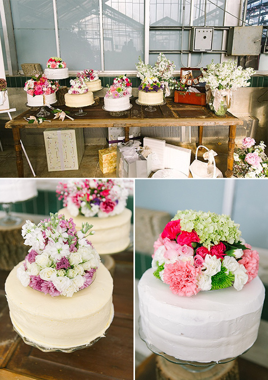 Wedding cakes decorated with colorful flowers and petals display