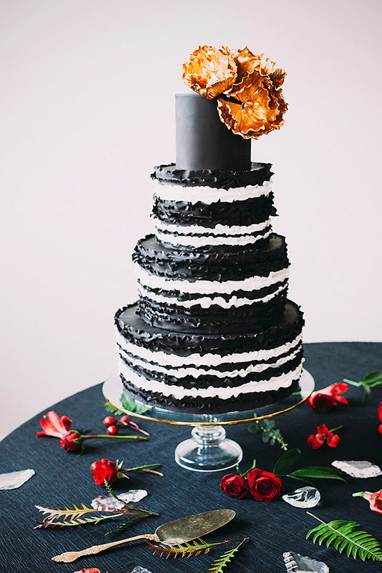 Elegant black and white cake with gold flowers for a special occasion