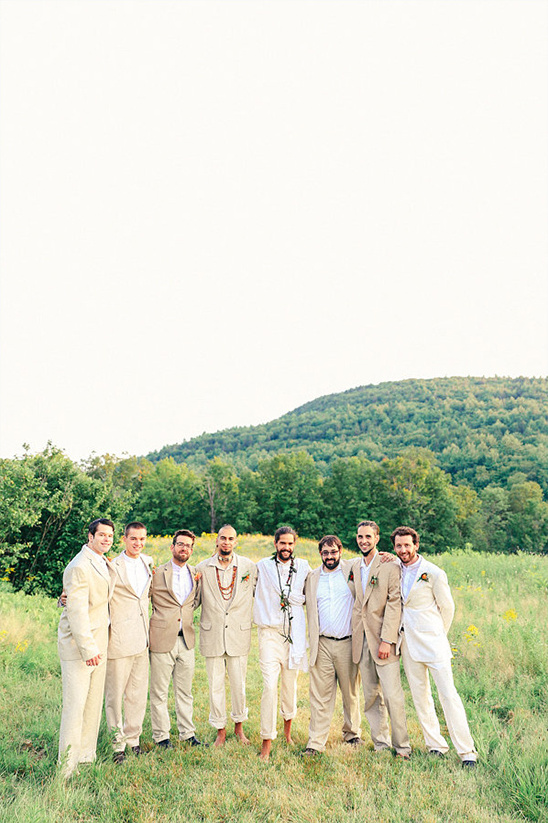 cream and white attire with barefoot groom and best man