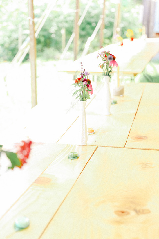 Rustic wedding table with wildflowers in vases