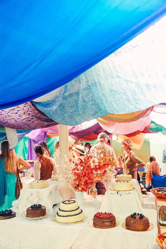 home made wedding cakes in colorful reception tent
