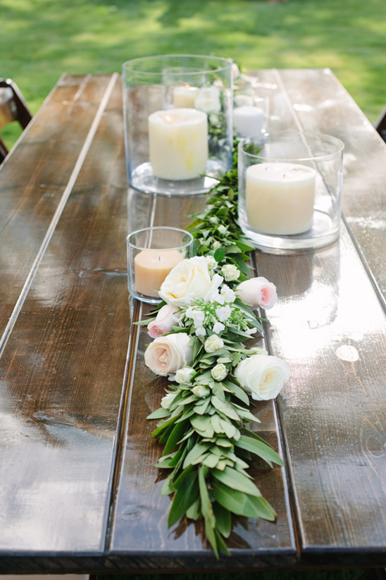rose garland and hurrican jar candle centerpieces