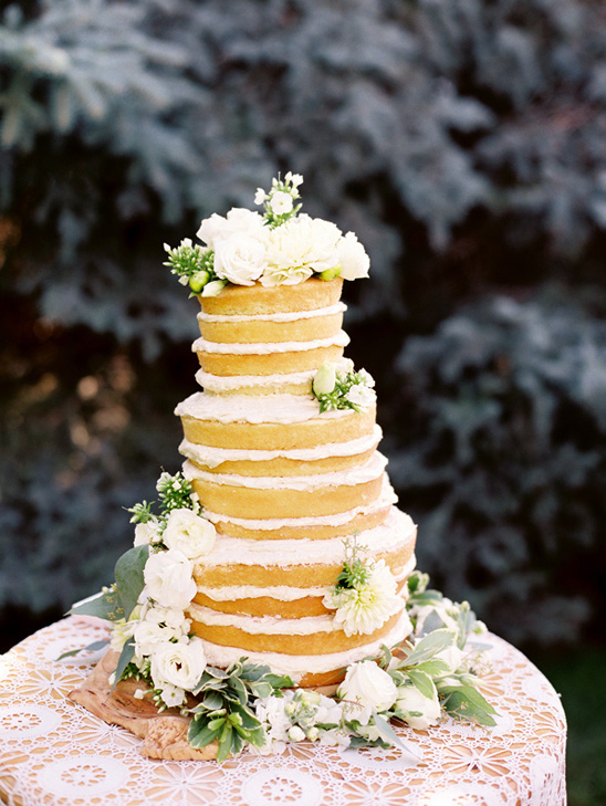 flower topped naked cake by The Patisserie