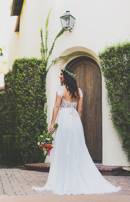 Bride in flowing white wedding gown, holding bouquet