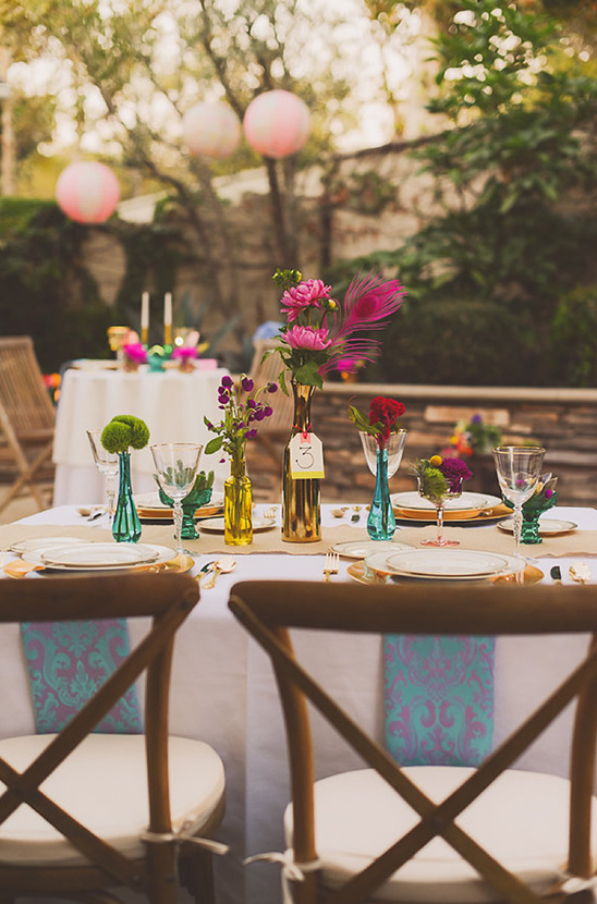 Vibrant outdoor wedding table setting with colorful flowers