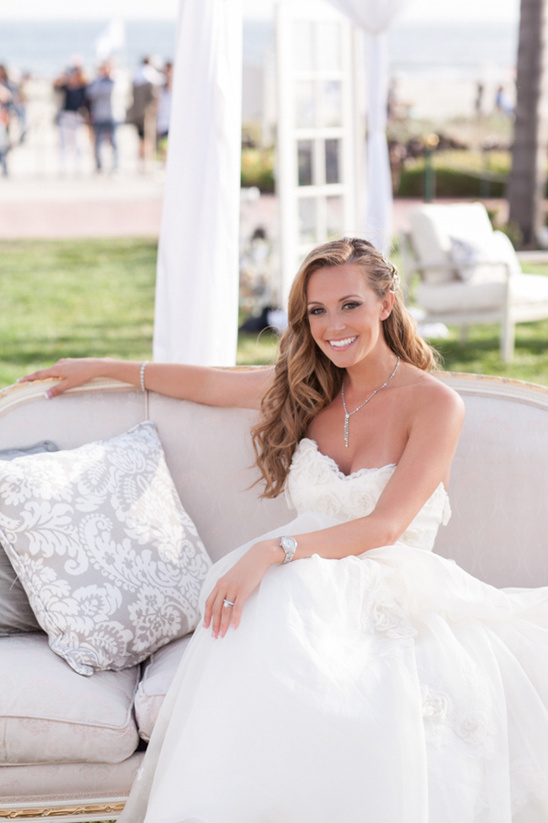 Beautiful bride in a white wedding dress smiles at the camera