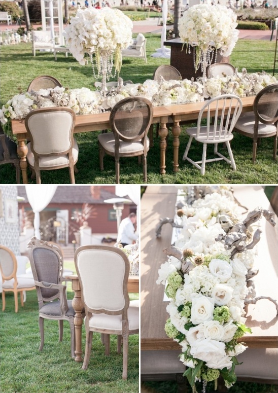 outdoor seating with elegant white flower and driftwood centerpieces