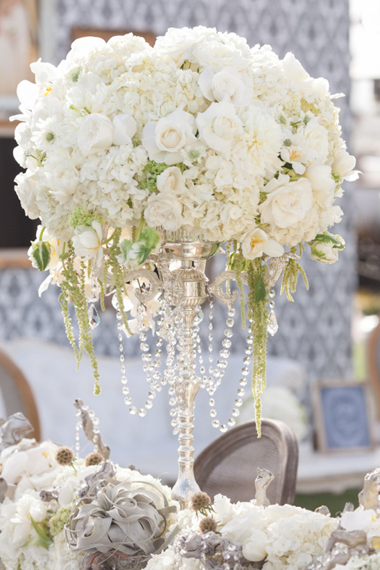 Elegant white floral centerpiece with crystal chandelier detail