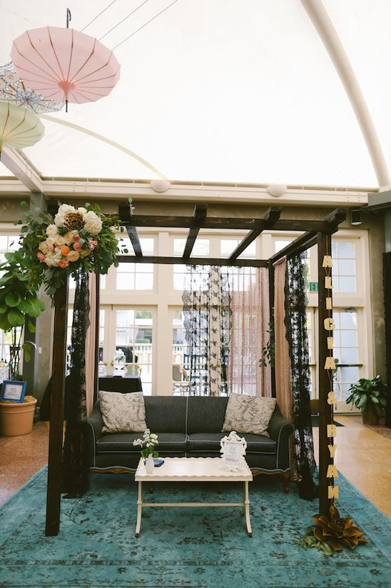 Romantic wedding lounge area with sofa and floral decor