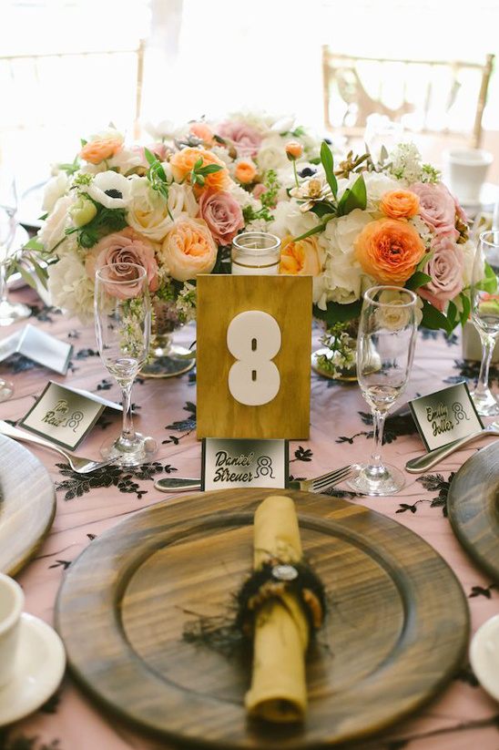 Table eight wedding centerpiece with peach and white flowers