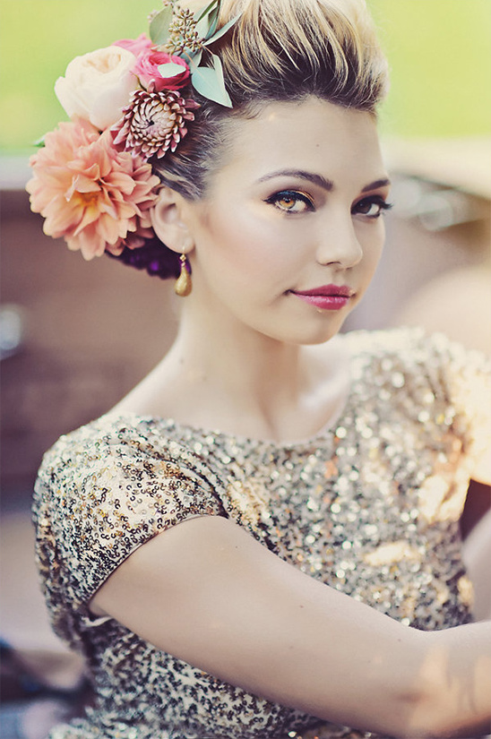 oversized floral hairpiece and dramatic glam makeup
