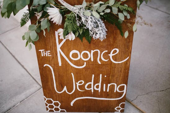 wooden wedding sign with flower garland