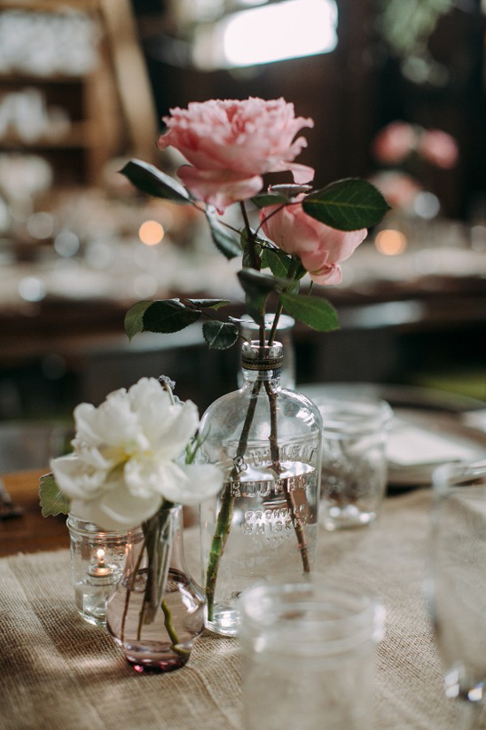 Elegant floral centerpiece with pink roses and candles