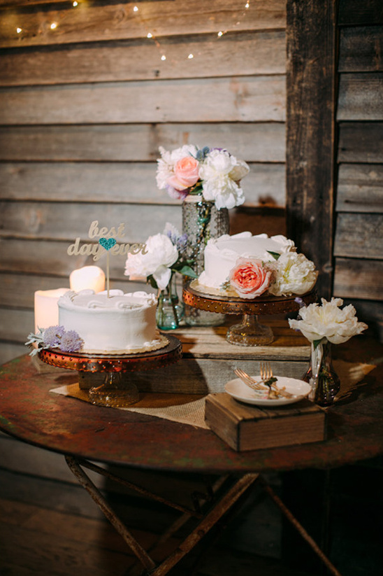 Rustic wedding cakes with flowers on an old table setting