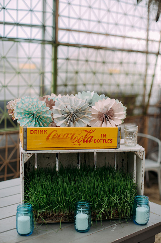 Vintage Coca-Cola crate decoration with paper fans and candles