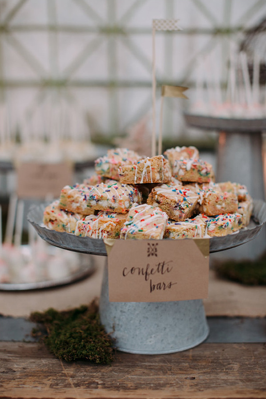 Confetti bars with sprinkles on a metal tray and wooden table