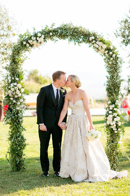 wedding arch and kiss