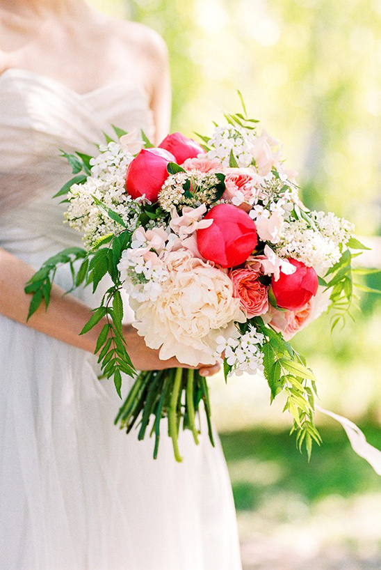 Bride holding beautiful pink and white peony wedding bouquet