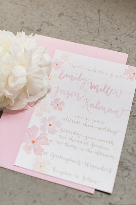 Wedding invitation with floral design and pink envelope