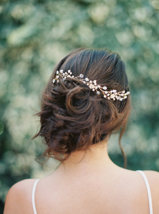 wedding updo with vine inspired hair pin