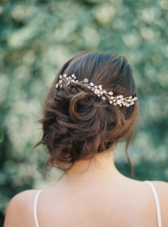 Elegant bride with updo hair and delicate wedding hair accessory