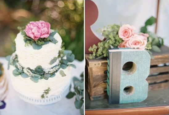 Wedding cake with flowers next to the letter B decorated with roses