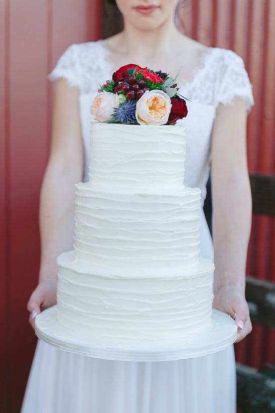 white wedding cake with floral topper