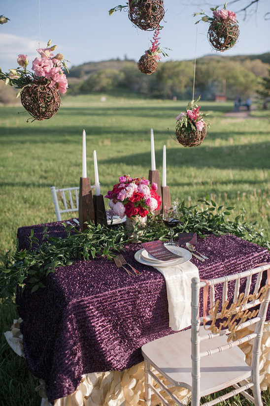 Romantic purple wedding table setting with floral decor
