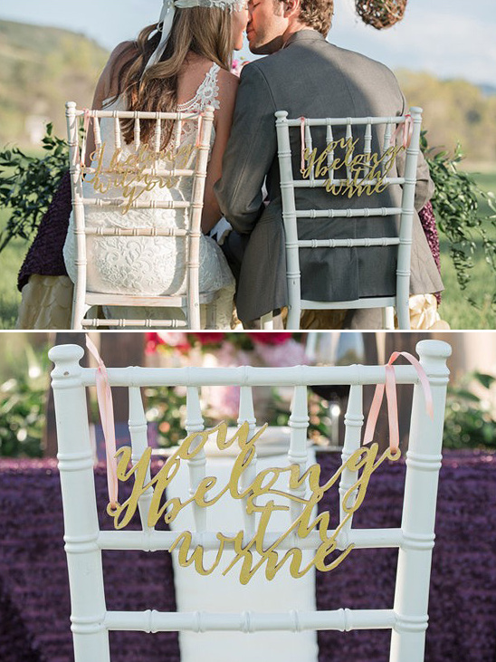 Wedding chairs decorated with You belong with me signs