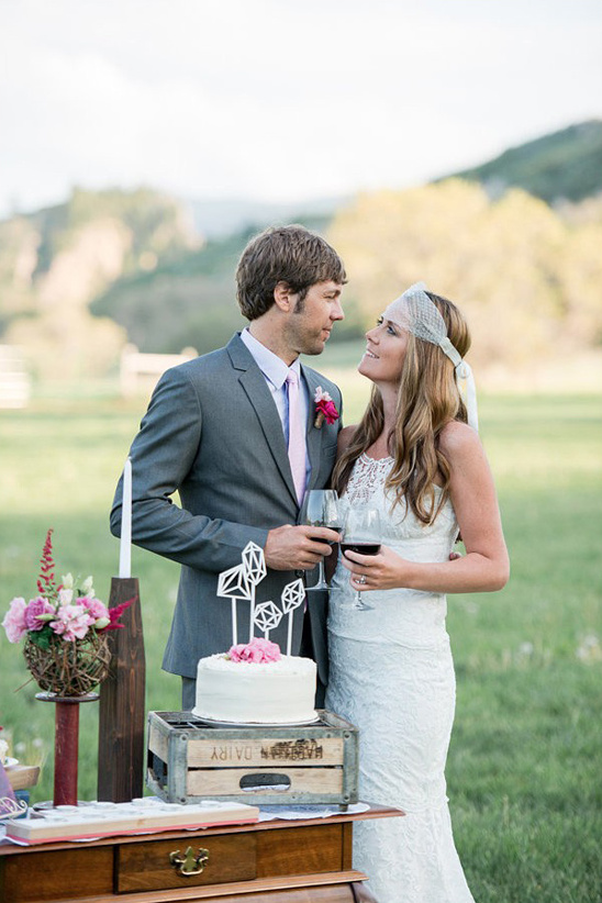 Newlyweds enjoying wine at a rustic outdoor wedding reception