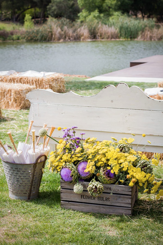 Rustic wedding decor:  flowers in crate near bench