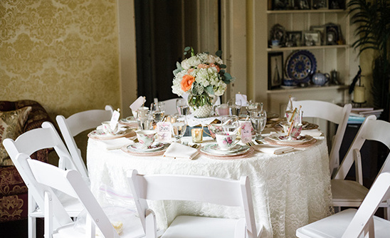 Elegant tea party table setting with floral centerpiece