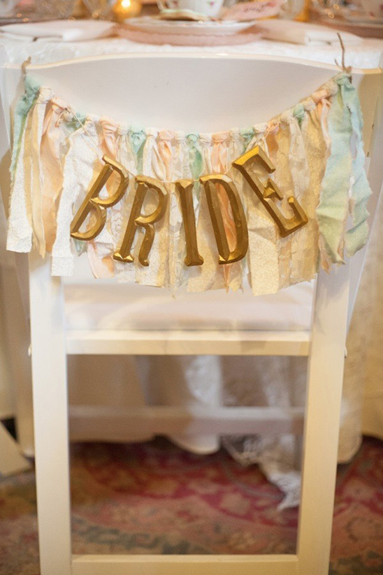 A charming BRIDE banner decorates a chair for a wedding
